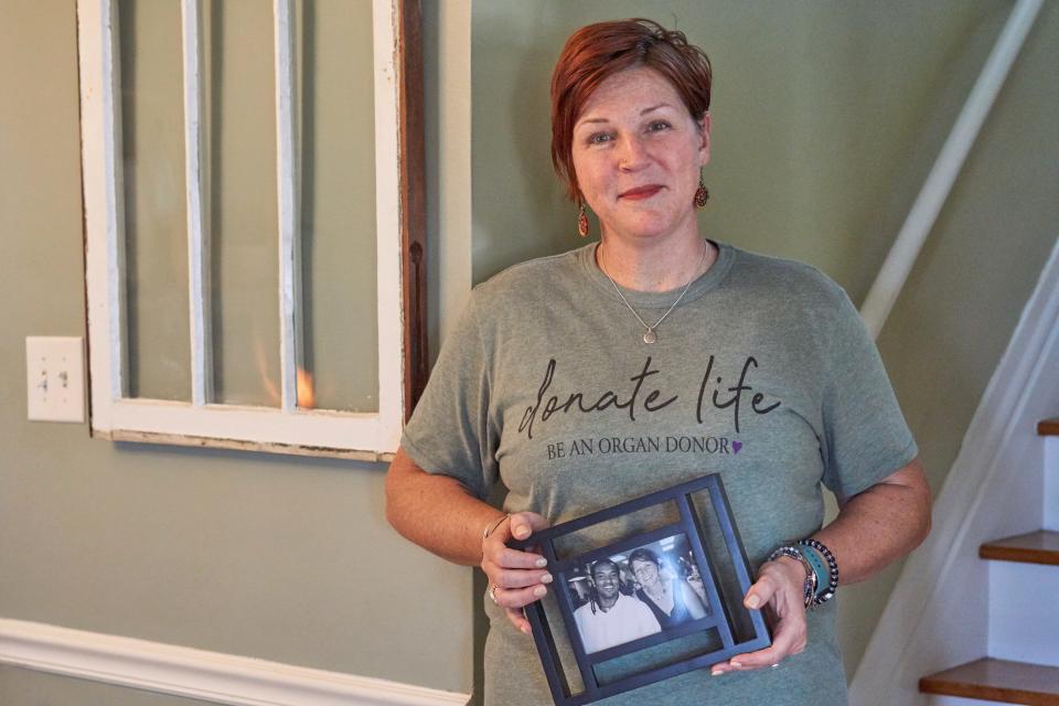 Cindy Windsor in her home in Des Moines, Iowa holding a photo of her and her husband, Freddie. Freddie was a heart and kidney recipient, then a cornea donor when he passed in 2020. He was a passionate organ donor advocate, just as Cindy is.