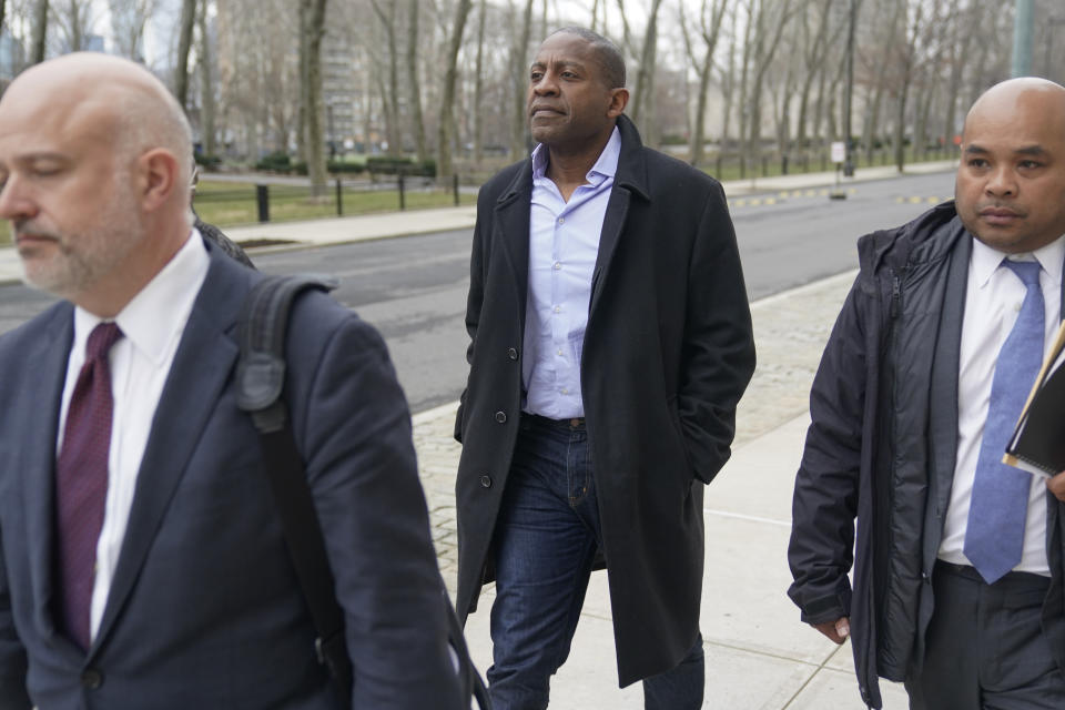 Carlos Watson, center, leaves Brooklyn federal court in New York, Thursday, Feb. 23, 2023. The founder of the troubled digital start-up Ozy Media has been arrested on fraud charges as part of what prosecutors say was a scheme to prop up the financially struggling company. (AP Photo/Seth Wenig)