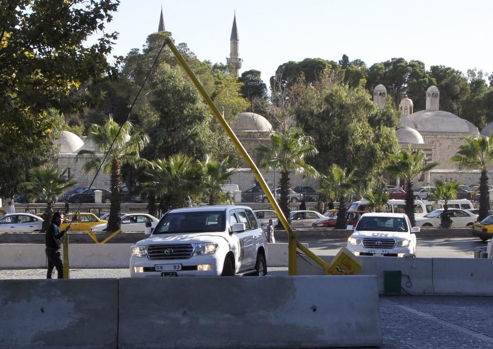 A U.N. convoy arrives at a hotel where experts from the Organisation for the Prohibition of Chemical Weapons (OPCW) are staying, in Damascus October 9, 2013. The head of the Hague-based global chemical weapons watchdog said on Wednesday that Syrian officials had been "quite cooperative" in the early stages of the destruction of Syria's chemical weapons arsenal. Ahmet Uzumcu, director general of the Organisation for the Prohibition of Chemical Weapons, said that international experts aimed to visit 20 sites in the coming days and weeks, and described their mission to eliminate Syria's chemical weapons by mid-2014 as "realistic" if they had international support. (REUTERS/Khaled al-Hariri)