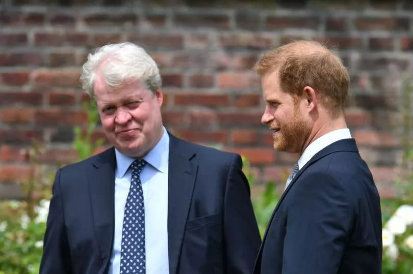 Britain's Prince Harry, Duke of Sussex (R) chats with his uncle Earl Spencer