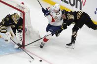 Boston Bruins' Charlie McAvoy (73) defends against Florida Panthers' Eetu Luostarinen (27) as Bruins' Jeremy Swayman (1) tends goal during the second period in Game 3 of an NHL hockey Stanley Cup second-round playoff series Friday, May 10, 2024, in Boston. (AP Photo/Michael Dwyer)