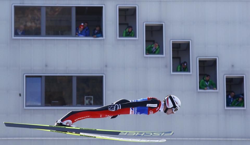 Switzerland's tournament overall leader Simon Ammann soars through the air to take the third place in the second jumping of the four-hills tournament in Garmisch-Partenkirchen, southern Germany, in this January 1, 2014 file photo. REUTERS/Kai Pfaffenbach/Files (GERMANY - Tags: TPX IMAGES OF THE DAY SPORT SKIING)