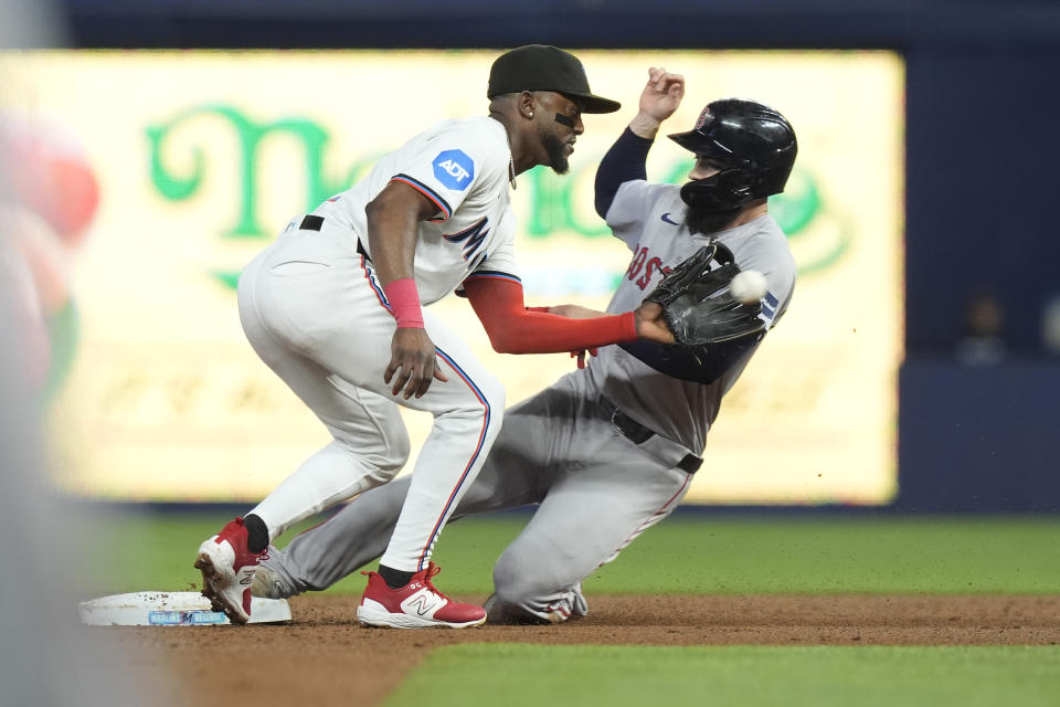Boston Red Sox's Connor Wong steals second base as Miami Marlins shortstop Vidal Bruján is late with the tag during the second inning of a baseball game, Wednesday, July 3, 2024, in Miami. (AP Photo/Marta Lavandier)