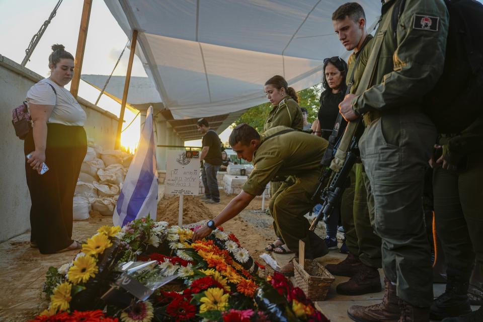 Mourners gather around the grave of Israeli soldier Capt. Shlomo Ben Nun, during his funeral in Modiin, Israel, Thursday, Nov. 16, 2023. Ben Nun, was killed during a military ground operation in the Gaza Strip. (AP Photo/Ohad Zwigenberg)