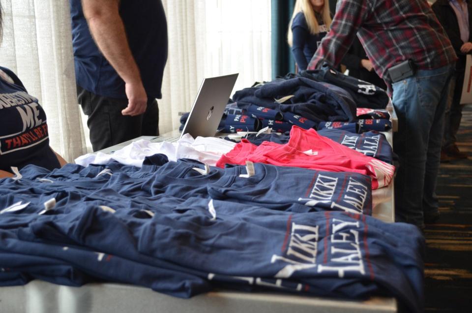 A table of T-shirts, pins, bumper stickers and more sit outside the ballroom doors.