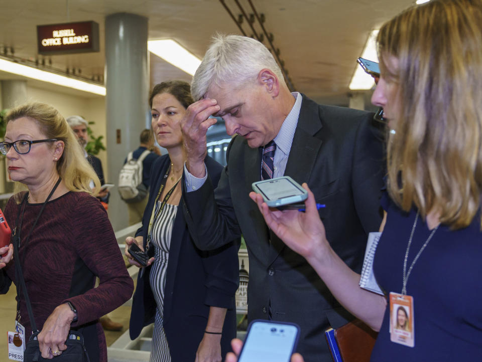 Sen. Bill Cassidy, R-La., is met by reporters as he walks to the chamber for a vote, at the Capitol in Washington, Thursday, June 10, 2021. Sen. Cassidy is working with a bipartisan group of 10 senators negotiating an infrastructure deal with President Joe Biden. (AP Photo/J. Scott Applewhite)