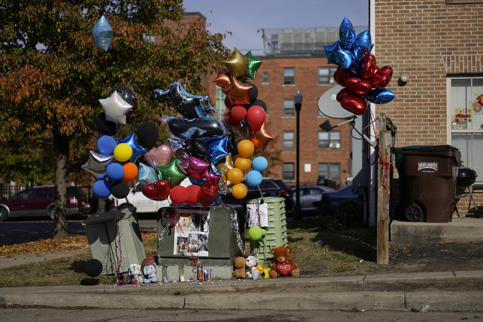 A makeshift memorial of balloons, stuffed animals, and photographs is seen Monday, Nov 6, 2023, in Cincinnati, for Dominic Davis, an 11-year-old boy, who was killed in a weekend shooting. Police Chief Terri Theetge told reporters Sunday that a shooter in a sedan fired 22 rounds "in quick succession" into a crowd of children just before 9:30 p.m. Friday on the city's West End. (AP Photo/Carolyn Kaster)