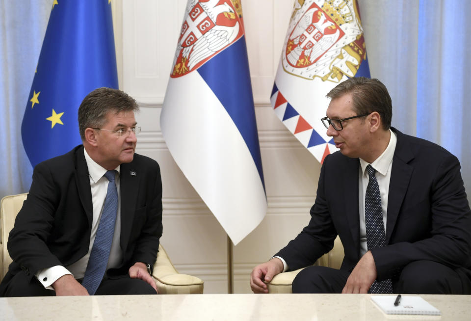 In this photo provided by the Serbian Presidential Press Service, Serbian President Aleksandar Vucic, right, speaks with European Union envoy Miroslav Lajcak in Belgrade, Serbia, Thursday, Aug. 25, 2022. Tensions between Serbia and Kosovo soared anew late last month when Kosovo's government declared that Serb-issued identity documents and vehicle license plates would no longer be valid in Kosovo's territory, as Kosovo-issued ones are not valid in Serbia. (Serbian Presidential Press Service via AP)