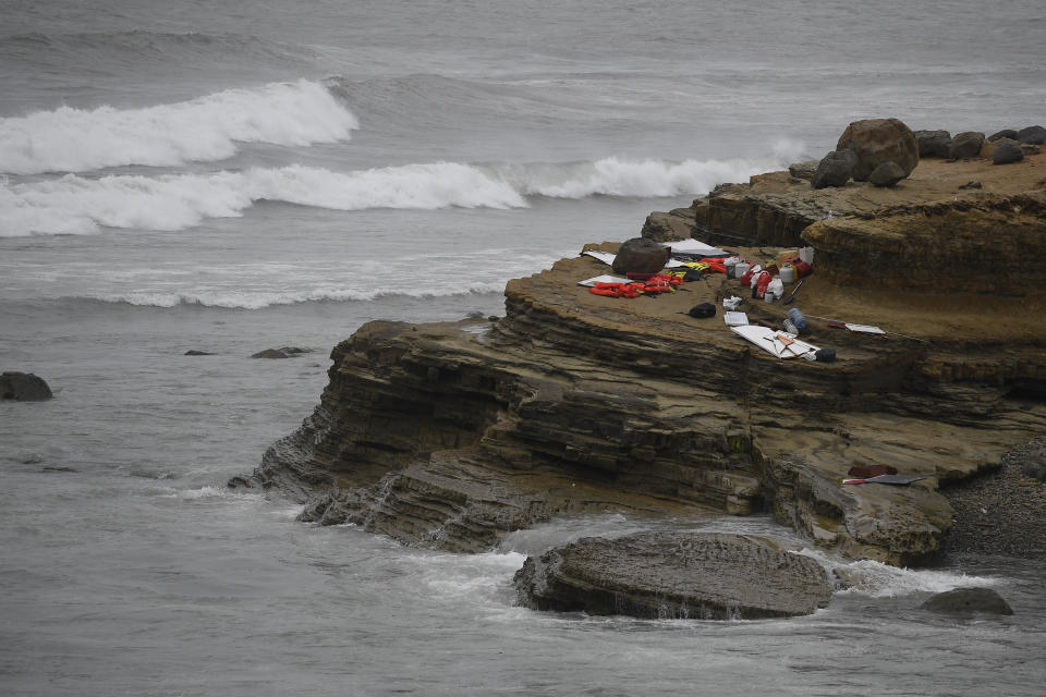 Items from a boat sit on the shoreline at Cabrillo National Monument near where it capsized just off the San Diego coast Sunday, May 2, 2021, in San Diego. Authorities say two people were killed and nearly two dozen others were hospitalized after the boat capsized. (AP Photo/Denis Poroy)