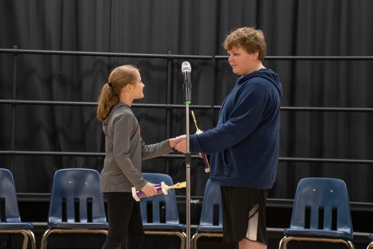 Ava Berger, left, runner-up in the B.L. Miller Elementary spelling bee, congratulates Carson Bevins, right, the event's victor. The pair competed for several rounds of back-and-forth spelling rounds.