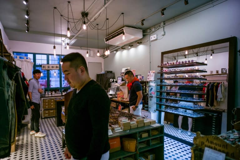 Customers browse locally designed fashion items at an independant shop in Hong Kong