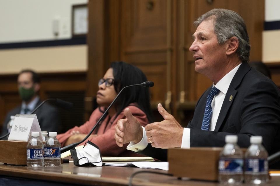 FILE - In this March 16, 2021, file photo Christopher Swecker, right, chairman of the Fort Hood Independent Review Committee speaks accompanied by Carrie Ricci, a member of the Fort Hood Independent Review Committee, during a House Committee on Armed Services Subcommittee on Military Personnel, hearing about Military Criminal Investigative Organization Reform Recommendations from the Fort Hood Independent Review Committee, on Capitol Hill in Washington. The Army said Friday, April 30, that it has taken disciplinary action against 21 officers and non-commissioned officers at Fort Hood, Texas, in connection with death last year of Spc. Vanessa Guillen, who was missing for about two months before her remains were found. (AP Photo/Alex Brandon)