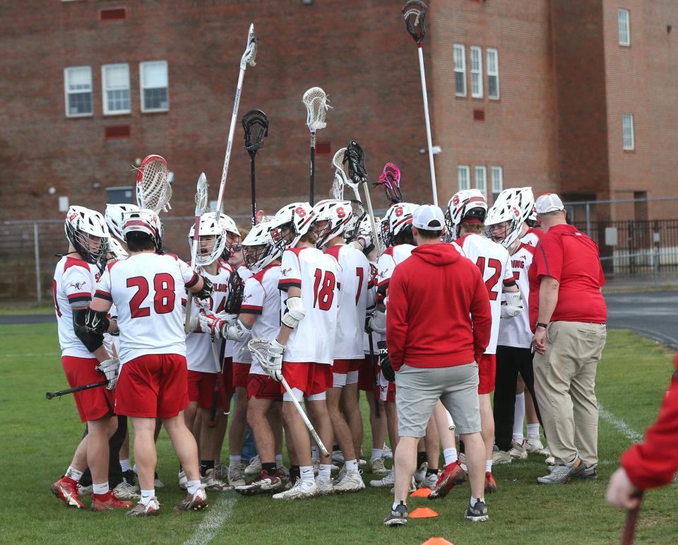 The Spaulding High School boys lacrosse team gather before the start of last Wednesday's Division II game against Hollis-Brookline. The Red Raiders broke a 62-game losing streak, dating back to the start of the 2019 season, last Tuesday, an 8-7 overtime win at Pembroke.