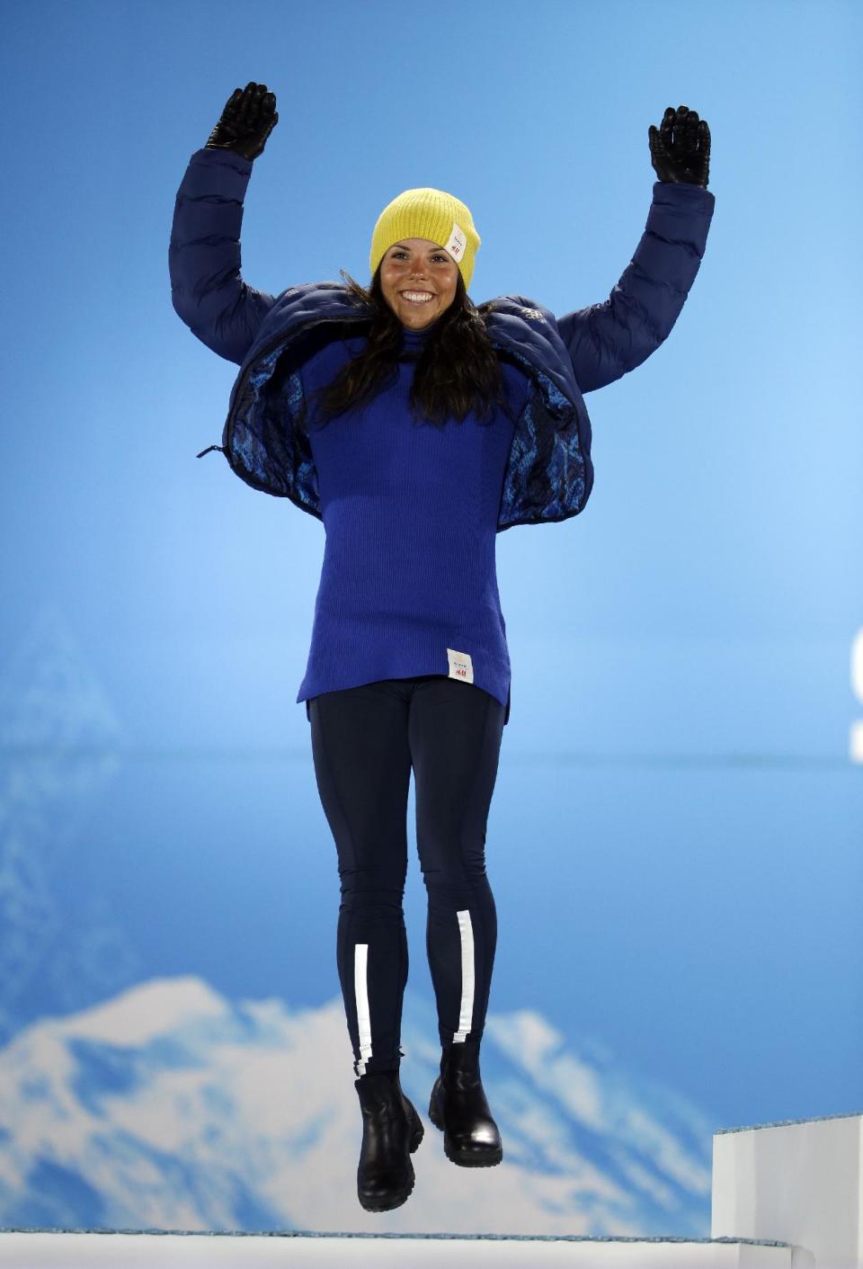 Charlotte Kalla of Sweden, the silver medalist in the women's cross-country 10K classical race, jumps on the podium during the medals ceremony at the 2014 Winter Olympics, Thursday, Feb. 13, 2014, in Sochi, Russia. (AP Photo/David Goldman)