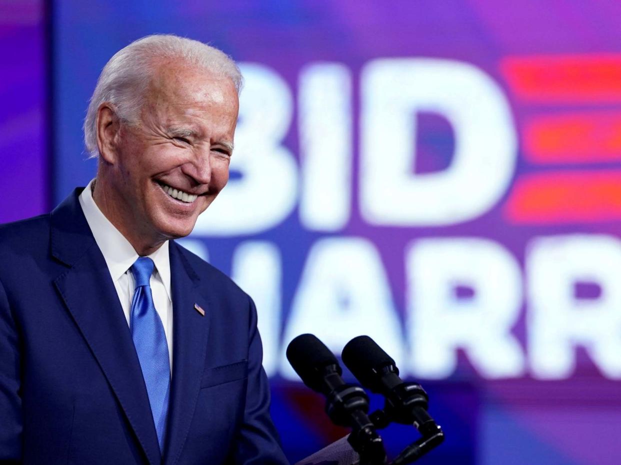 Joe Biden smiles at a press conference in Delaware: REUTERS
