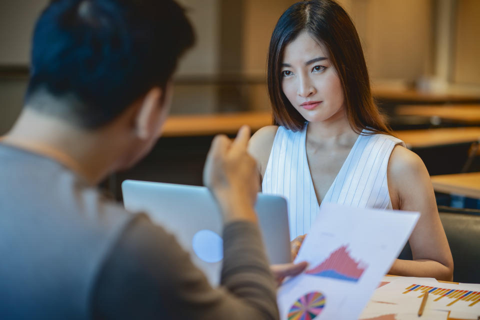 Business mistake and punish concept, Reaw view of Furious boss scolding asian young businesswoman in casual suit by point to her face about performance and KPI in modern office