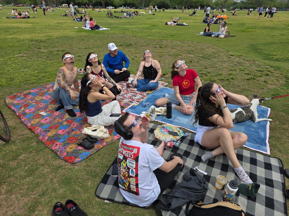 Eclipse watchers gather at Zilker Park in Austin, Texas on April 8, 2024 to watch the solar eclipse.