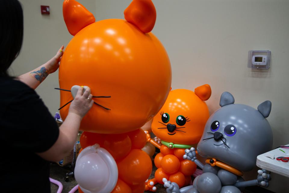 Balloon artist Louise Fama, from Windsor, Ontario, puts the whiskers on a cat Wednesday, April 24, 2024, ahead of the Big Balloon Build charity event this weekend at the Northern Indiana Event Center in Elkhart County.