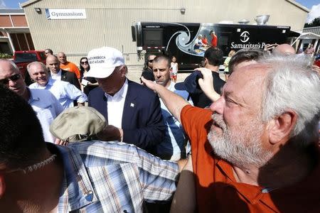 Republican presidential nominee Donald Trump signs a hat outside Greenwell Springs Baptist Church in Central, Louisiana, U.S. August 19, 2016. REUTERS/Jonathan Bachman