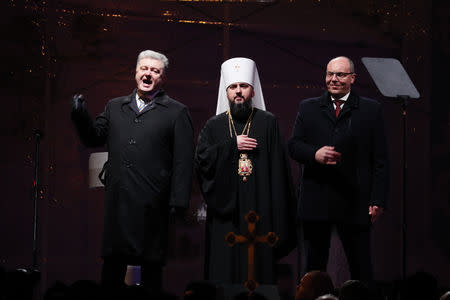 Ukraine's President Petro Poroshenko and Parliamentary Speaker Andriy Parubiy congratulate newly elected head of the independent Ukrainian Orthodox church Metropolitan Epifaniy (Dumenko) at the Saint Sophia's Cathedral in Kiev, Ukraine December 15, 2018. REUTERS/Gleb Garanich