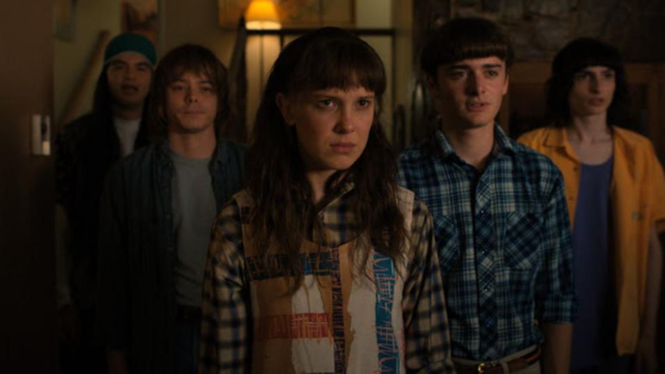photo of several stranger things characters standing together