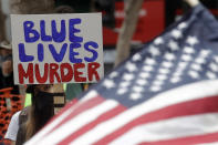 A woman holds a sign at a protest over the Memorial Day death of George Floyd, a handcuffed black man in police custody in Minneapolis, in San Francisco, Saturday, May 30, 2020. (AP Photo/Jeff Chiu)