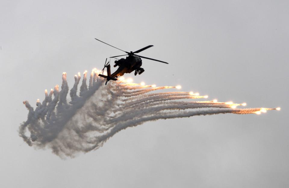 An AH-64 Apache attack helicopter releases flares during the Han Kuang drill at the Ching Chuan Kang (CCK) air force base in Taichung, central Taiwan, on June 7, 2018.