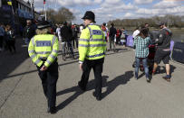 Police patrol the area, prior to the Men's Boat Race on the River Thames, in London., Sunday April 2, 2017. The annual Oxford-Cambridge boat race will proceed as planned Sunday after police removed an unexploded World War II-era bomb found near the start of the race on the River Thames. (Andrew Matthews/PA via AP)