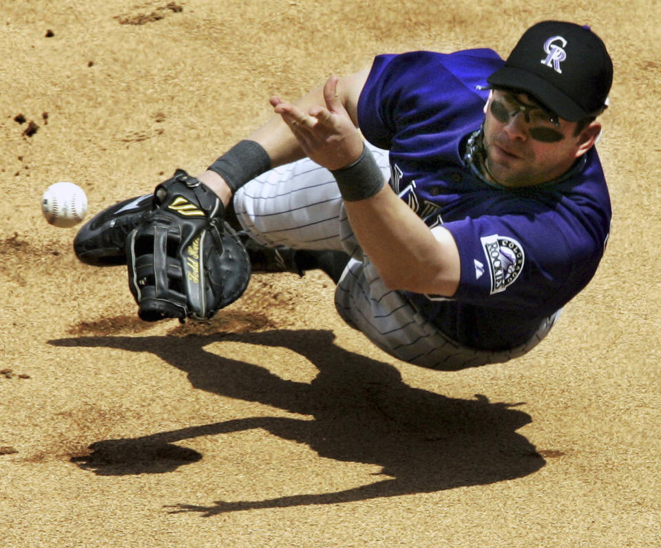 FILE - Colorado Rockies first baseman Todd Helton recovers a ball he misplayed off the bat of Pittsburgh Pirates' Humberto Cota and tosses to Rockies pitcher Joe Kennedy to make the out at first base during the fifth inning Sunday, May 22, 2005, in Pittsburgh. Helton, Billy Wagner and Scott Rolen are leading contenders to be elected to baseball's Hall of Fame in the Baseball Writers' Association of America vote announced Tuesday, Jan. 24, 2023.(AP Photo/Gene J. Puskar, File)