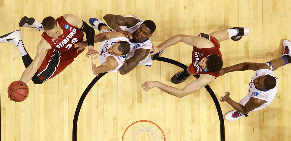 Stanford forward Dwight Powell drives to the basket against Kansas forward Perry Ellis in second half action during a Third Round NCAA Tournament game between Kansas and Stanford on Sunday, March 23, 2014, at the Scottrade Center in St. Louis. (AP Photo/St. Louis Post-Dispatch, Chris Lee)