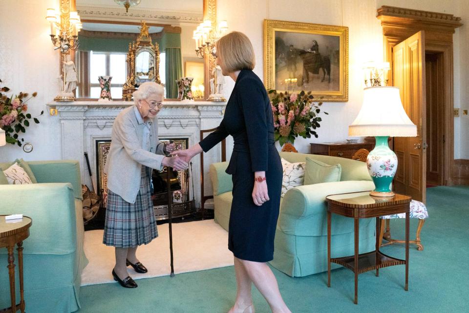 Queen Elizabeth II greets Liz Truss, her 14th prime minister and Britain's third woman premier, when she arrived at the queen's Balmoral Castle in Scotland on Sept. 6, 2022, to be invited to form a new government.