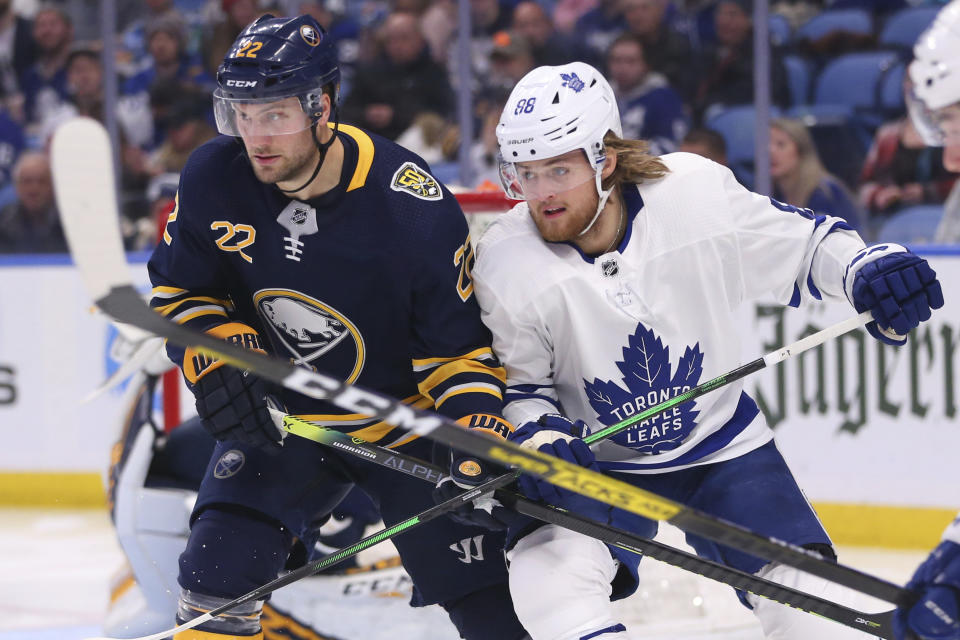Buffalo Sabres forward Johan Larsson (22) and Toronto Maple Leafs forward William Nylander (88) battle for position during the second period of an NHL hockey game Sunday, Feb. 16, 2020, in Buffalo, N.Y. (AP Photo/Jeffrey T. Barnes)
