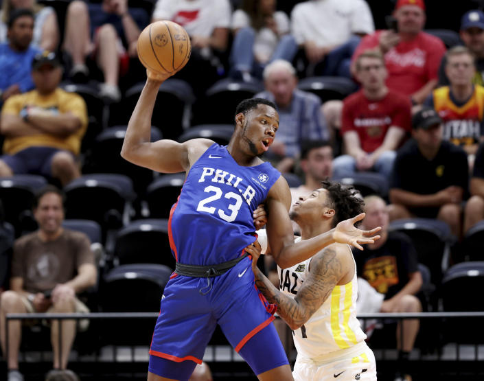 Philadelphia 76's Charles Bassey (23) brings down a high pass and tries to spin to the hoop on Utah Jazz's Caleb Homesley (61) in summer league basketball game in Salt Lake City on Wednesday, July 6, 2022. (Scott G Winterton/The Deseret News via AP)