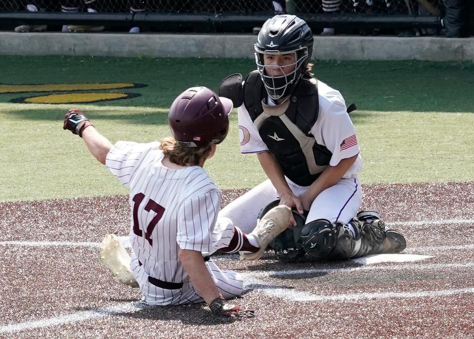 Onsted catcher Alex Schmidt tags out a Buchanan base runner during Saturday's MHSAA Division 3 regional final at Nicolay Field on the campus of Adrian College.