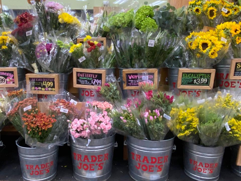 Bunches of flowers in buckets at Trader Joe's