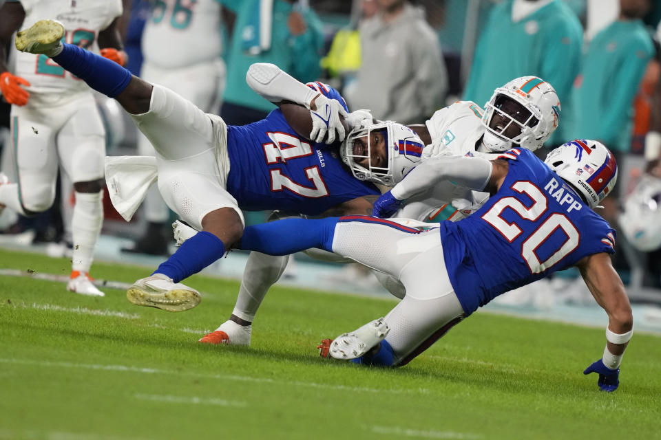 Buffalo Bills cornerback Christian Benford (47) intercepts a pass intended for Miami Dolphins wide receiver Tyreek Hill (10) during the first half of an NFL football game, Sunday, Jan. 7, 2024, in Miami Gardens, Fla. (AP Photo/Lynne Sladky)