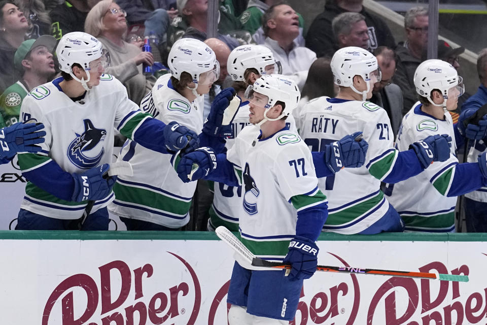 Vancouver Canucks left wing Anthony Beauvillier (72) celebrates with the bench after scoring in the first period of an NHL hockey game against the Dallas Stars, Monday, Feb. 27, 2023, in Dallas. (AP Photo/Tony Gutierrez)
