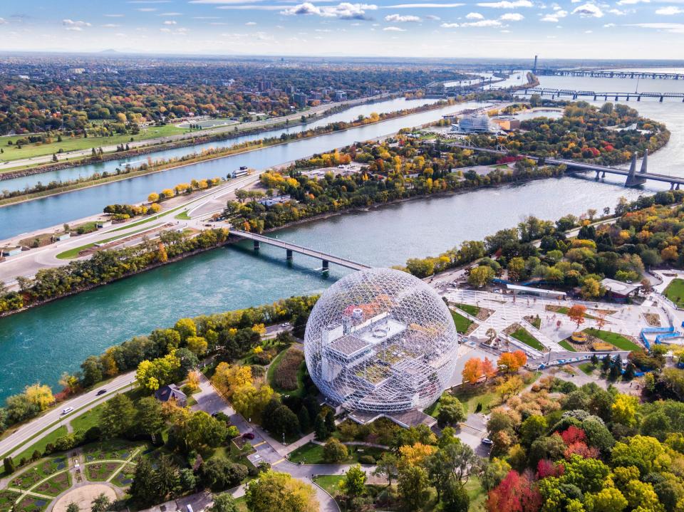 An aerial view of Montreal shows the Biosphere Environment Museum and the Saint Lawrence River.