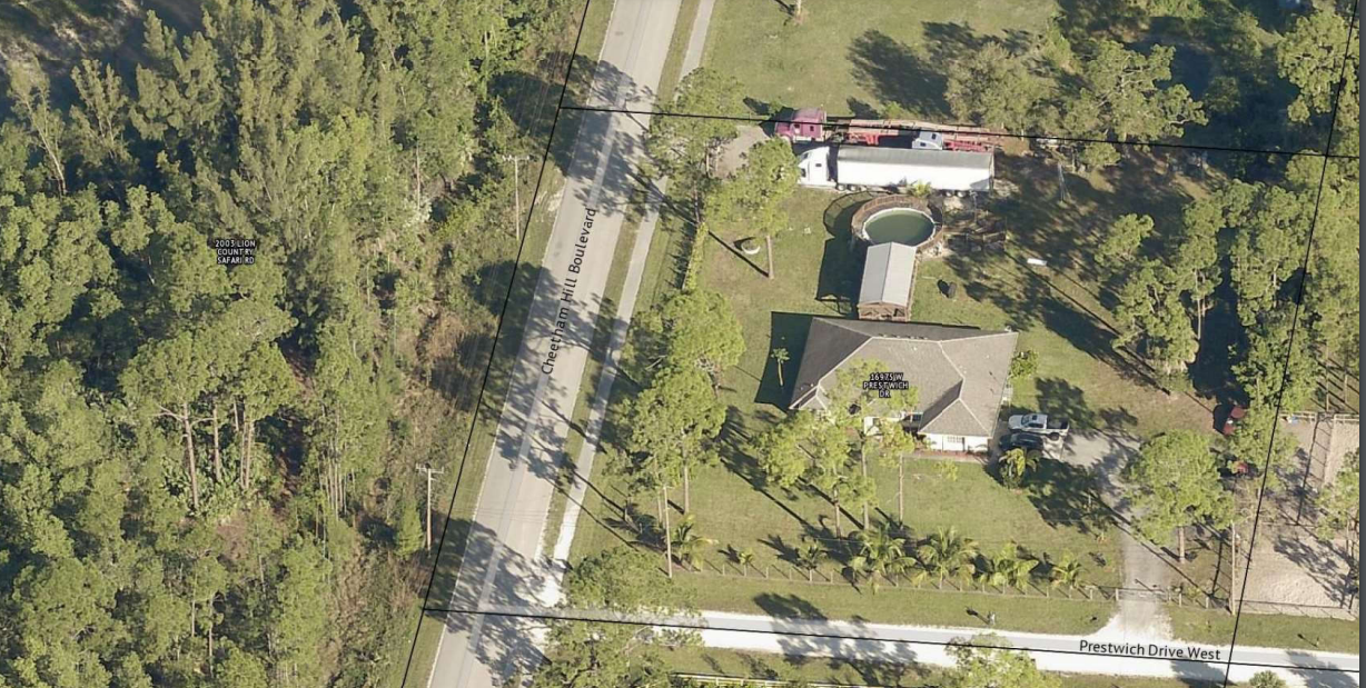 Picture shows two large semi trucks on a property in the Acreage area in violation of the county's zoning code