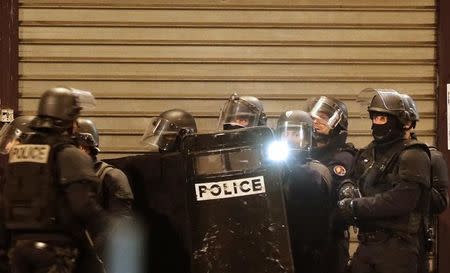 French special police forces secure the area as shots are exchanged in Saint-Denis, near Paris, France, November 18, 2015 during an operation to catch fugitives from Friday night's deadly attacks in the French capital. REUTERS/Christian Hartmann