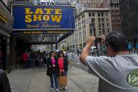 A fan stops to take a photograph of the outside of Ed Sullivan Theater in Manhattan as David Letterman prepares for the taping of tonight's final edition of "The Late Show" in New York May 20, 2015. (REUTERS/Lucas Jackson)