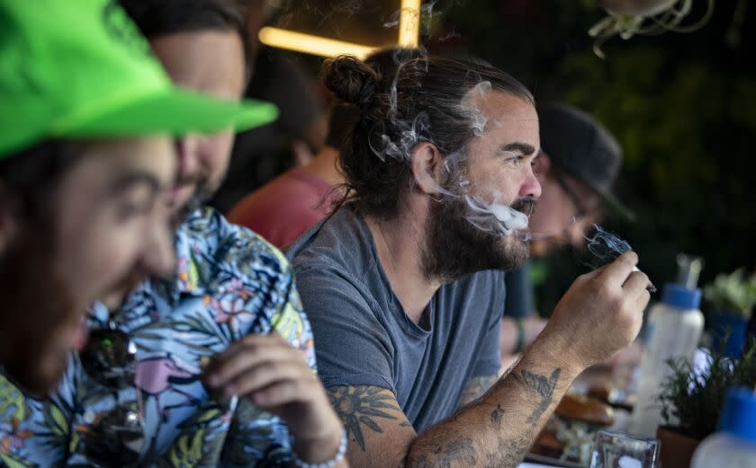 WEST HOLLYWOOD, CALIF. -- TUESDAY, OCTOBER 1, 2019: Patrons smoke cannabis at the Lowell Cafe a new restaurant and cannabis bar in West Hollywood allows diners to smoke marijuana inside and out thanks to a new license issued by the city in West Hollywood, Calif., on Oct. 1, 2019. (Brian van der Brug / Los Angeles Times)