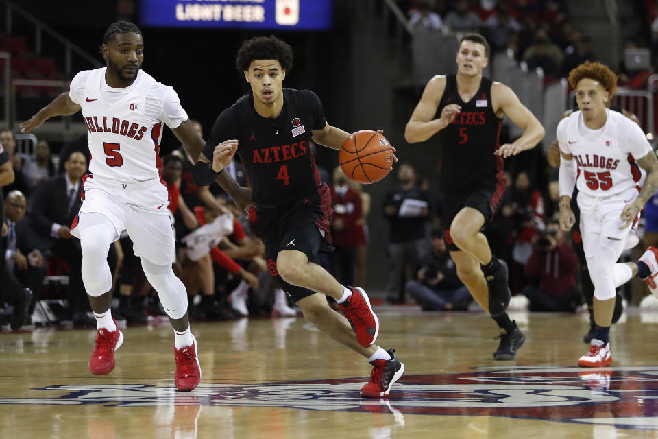 San Diego State's Trey Pulliam drives next to Fresno State's Jordan Campbell, left, during the first half of an NCAA college basketball game in Fresno, Calif., Tuesday Jan. 14, 2020. (AP Photo/Gary Trey Pulliam