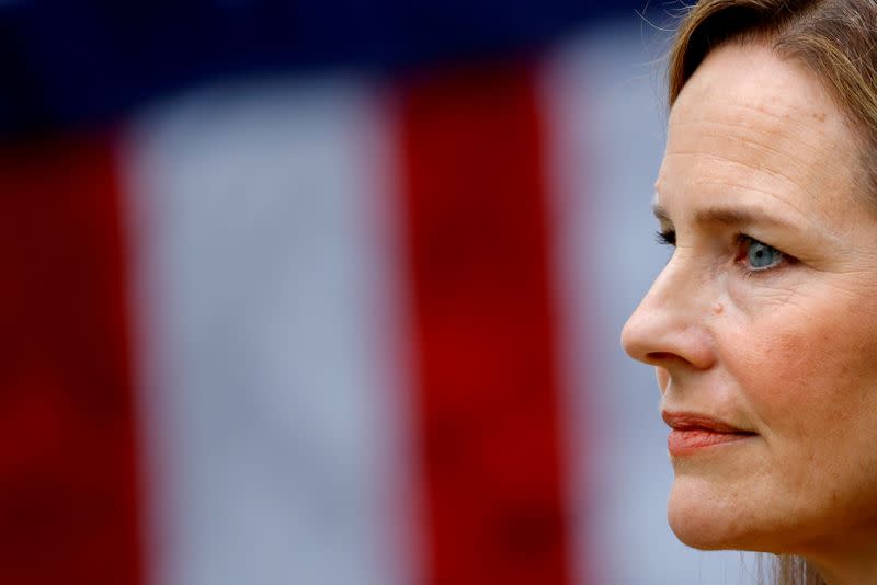 FILE PHOTO: U.S. Court of Appeals for the Seventh Circuit Judge Amy Coney Barrett stands as U.S President Donald Trump holds an event to announce her nomination for the Supreme Court at the White House in Washington