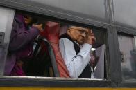 Historian Ramchandra Guha flashes the victory sign from a bus after being taken into custody by police at the Town Hall during a protest held against India's new citizenship law in spite of a curfew in Bangalore on December 19, 2019. - Indians defied bans on assembly on December 19 in cities nationwide as anger swells against a citizenship law seen as discriminatory against Muslims, following days of protests, clashes and riots that have left six dead. (Photo by Manjunath Kiran / AFP) (Photo by MANJUNATH KIRAN/AFP via Getty Images)