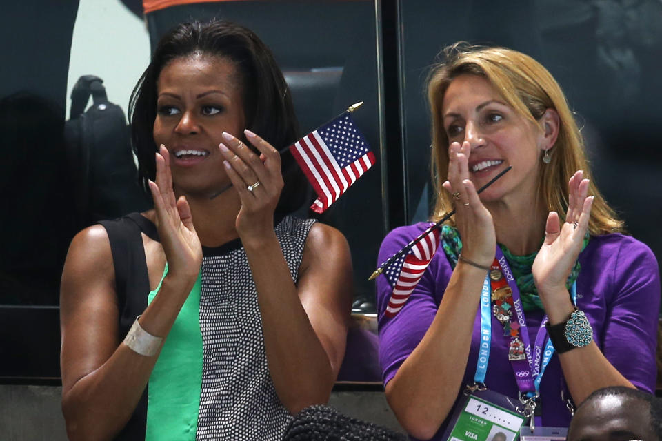 First Lady of the United States, Michelle Obama supports the USA Olympic Swim team along with Summer Sanders durng the evening session of the swimming on Day 1 of the London 2012 Olympic Games at the Aquatics Centre on July 28, 2012 in London, England. (Photo by Clive Rose/Getty Images)