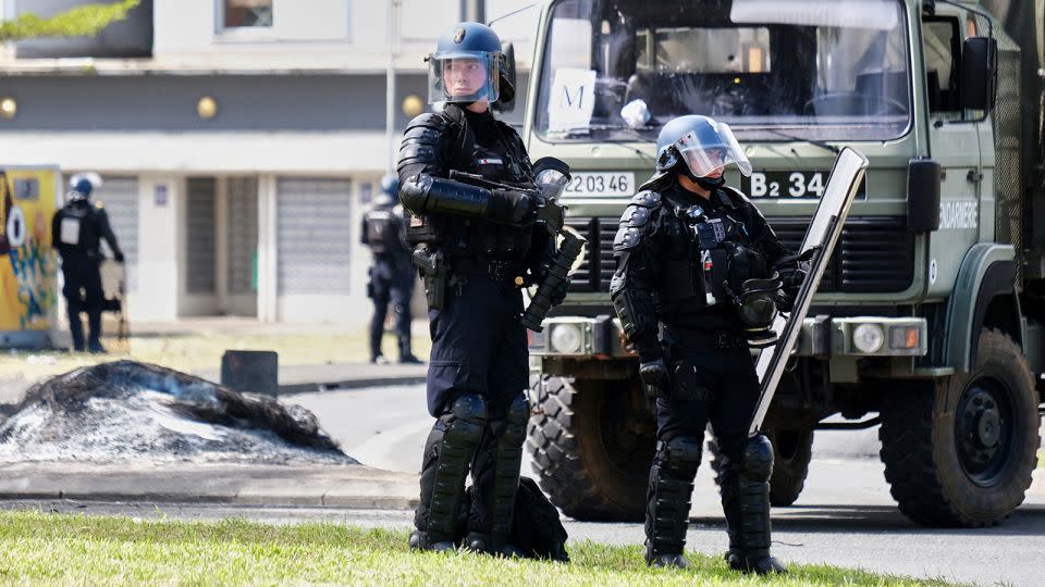 French gendarme officers guard the entrance of the Vallee-du-Tir district, in Noumea, New Caledonia on May 14, 2024. - Theo Rouby/AFP/Getty Images