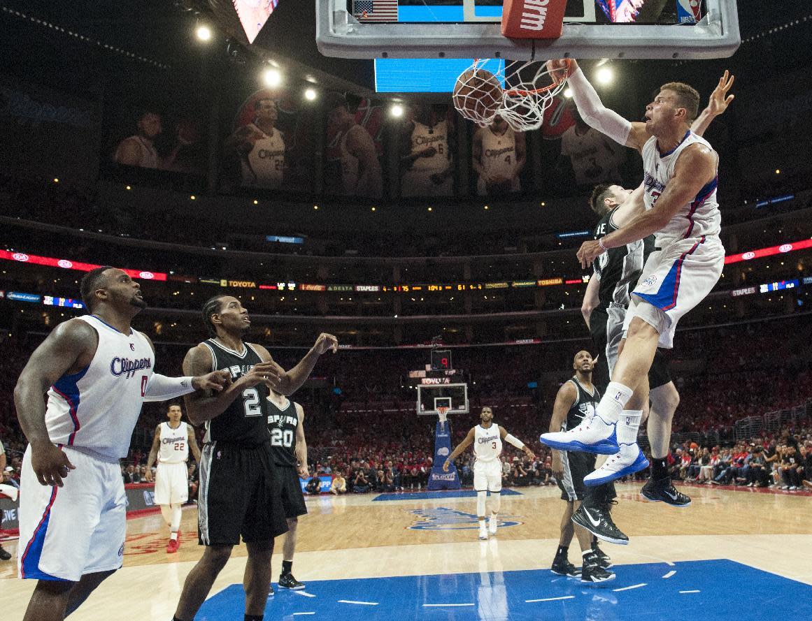 Los Angeles Clippers Blake Griffin dunks against San Antonio Spurs Aron Baynes during the second half of Game 1 of a first-round NBA basketball playoff series in Los Angeles, Sunday, April 19, 2015. (Ed Crisostomo/The Orange County Register via AP) MAGS OUT; LOS ANGELES TIMES OUT