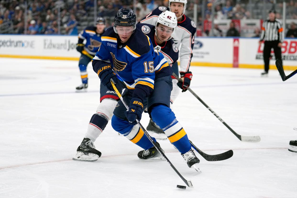St. Louis Blues' Jakub Vrana (15) controls the puck as Columbus Blue Jackets' Alexandre Texier (42) defends during the second period of a preseason NHL hockey game Tuesday, Sept. 26, 2023, in St. Louis. (AP Photo/Jeff Roberson)