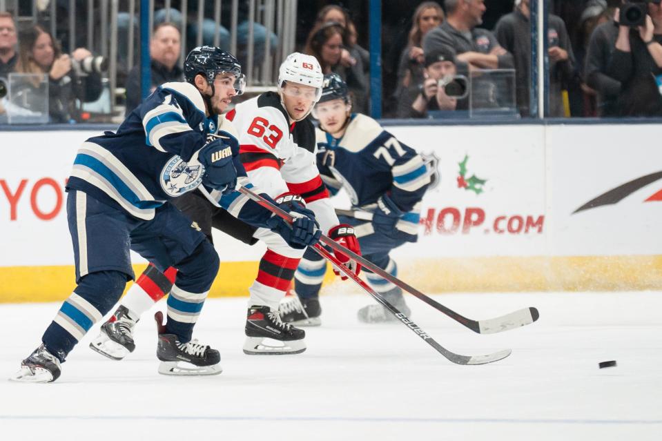 Dec 16, 2023; Columbus, Ohio, USA;
Columbus Blue Jackets left wing Johnny Gaudreau (13) passes the puck past New Jersey Devils left wing Jesper Bratt (63) during the second period of their game on Saturday, Dec. 16, 2023 at Nationwide Arena.